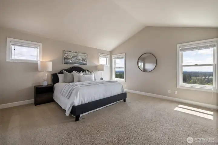 Expansive primary suite with multiple windows bringing in natural light