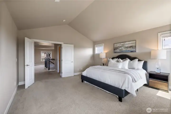 Double-door entry to the spa-inspired primary bathroom