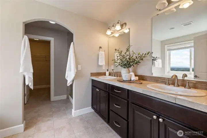 Double-door entry to the spa-inspired primary bathroom