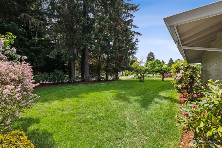 long paved  driveway lined with blooming flowers and apple trees sets the tone from the moment you arrive.