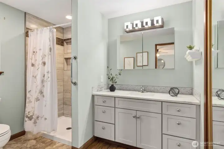 Updated primary bathroom featuring a convenient walk-in shower.