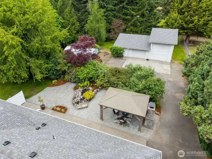 Expansive backyard featuring full paving, a charming she shed, and an oversized RV garage/shop.