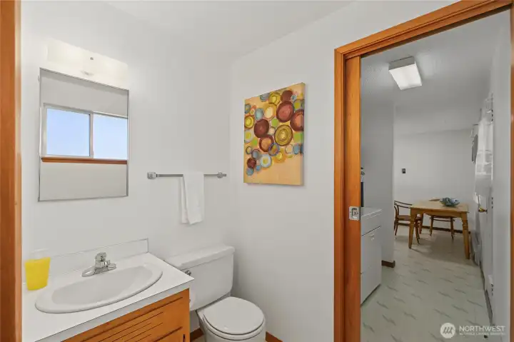 Half bath w/ pocket doors to primary and laundry room Half bath w/ pocket doors to primary and laundry room