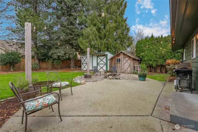 Patio, firepit and outbuildings