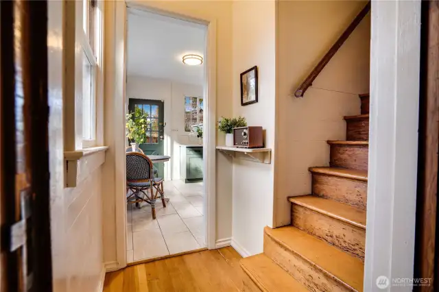 From the den, enter this hall where the back staircase leads up to the 5 second floor bedrooms and full bath. Move through to visit the updated kitchen.