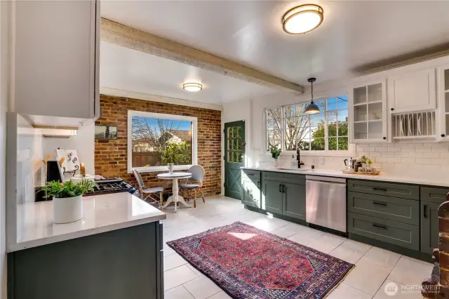 Different eras join to create a kitchen both up-to-date and full of charm. The brick wall to the south draws the eye and lends an element of solidity and old world character. West facing windows pull in natural light long into the evenings in summer and for as long as we can get it in the darker seasons.