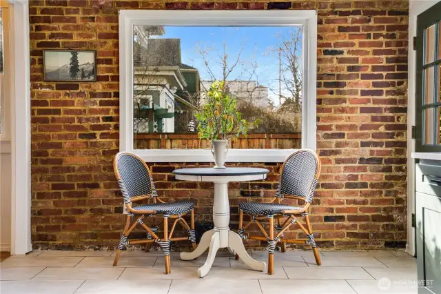 Set up a breakfast table, a spot for afternoon coffee breaks, a place for family and friends to sit and keep you company while you cook. The door to the right opens to the back steps which lead directly to the patio for outdoor dining.