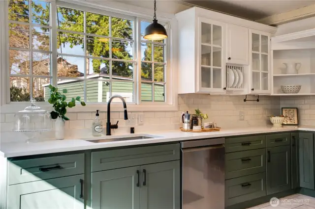 Enjoy the new cabinets and general kitchen refresh recently completed by the homeowners. The kitchen is equipped with a full set of appliances including the dishwasher shown here.