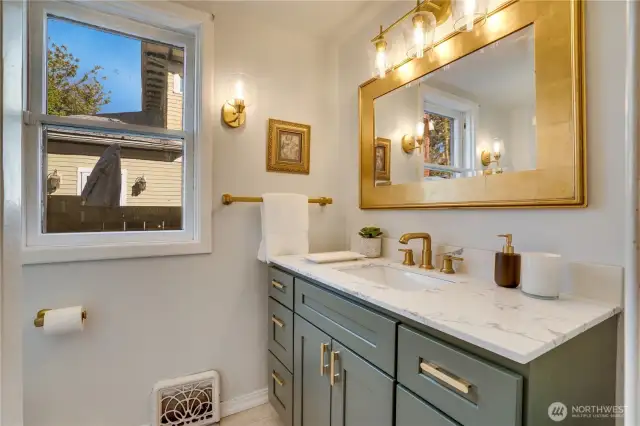 Take the hall toward the dining room to reach this recently refreshed 3/4 bathroom with its new vanity, mirror, and lighting. Each floor of the home (excluding the basement) offers a bathroom. Shower here, visit the 2nd floor full bath, or find the 3rd floor 3/4 bath with its shower.