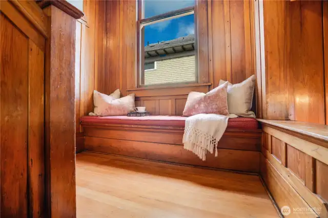 A picturesque window seat waits on the landing.