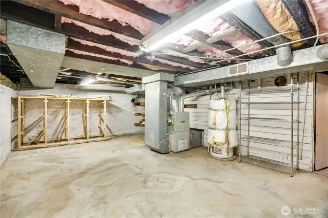 Reach the unfinished basement via stairs off the kitchen hallway. Down here you'll find the washer and dryer (new in 2020), along with the furnace, water heater, and storage space.