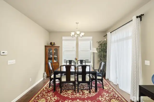Dining room next to sliding door that opens to the backyard covered patio with gas fire place.