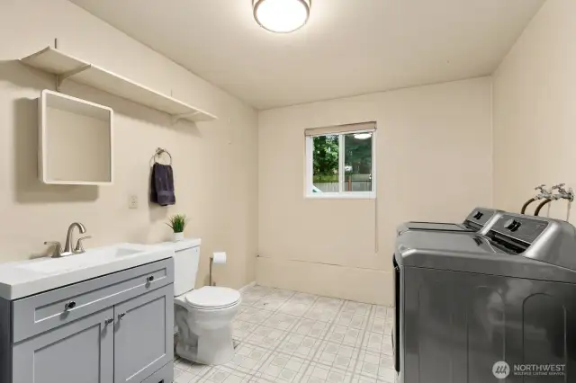 LL bathroom with mechanical and laundry. Plumbed with a drain for shower.