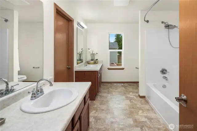 PRIMARY BATH - has a  5-piece bath with double sinks, separate cabinets, a linen closet, a large walk-in closet, and a window for fresh air.