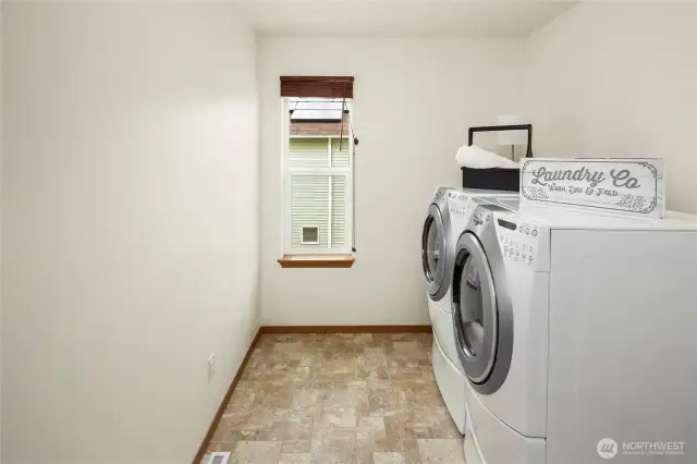 Dedicated laundry room  with Whirlpool matching Washer and Dryer with the added storage drawers below, whole house vent control and another window
