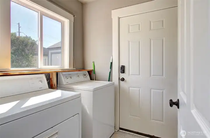 Laundry off kitchen with door to backyard
