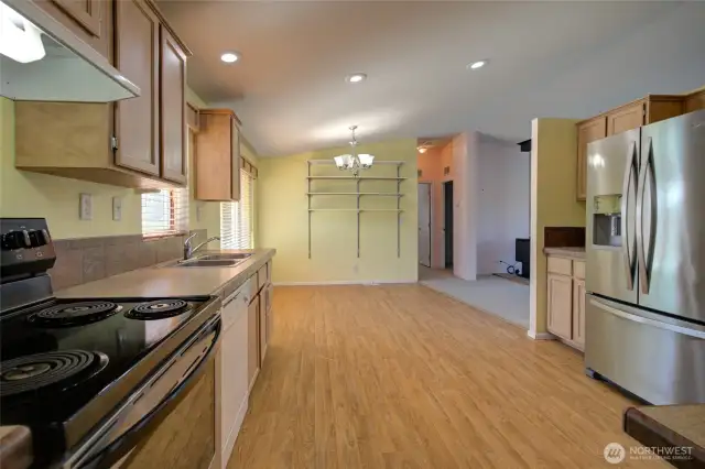 Kitchen has lots of cabinets and walk in pantry