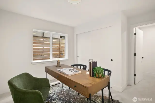 On the entry level, just off of the family room/den, there's a bedroom (or currently staged as an office).
