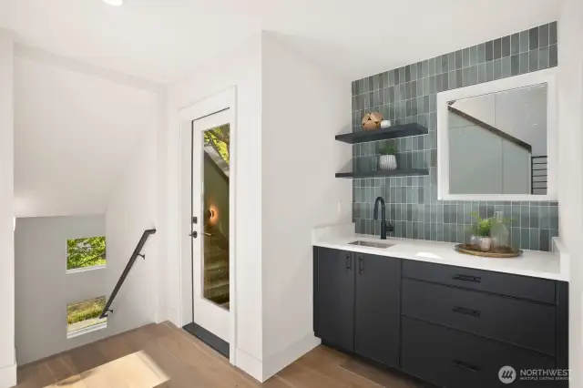 The upper level has a wet bar and the door in the photo leads to the rooftop deck.