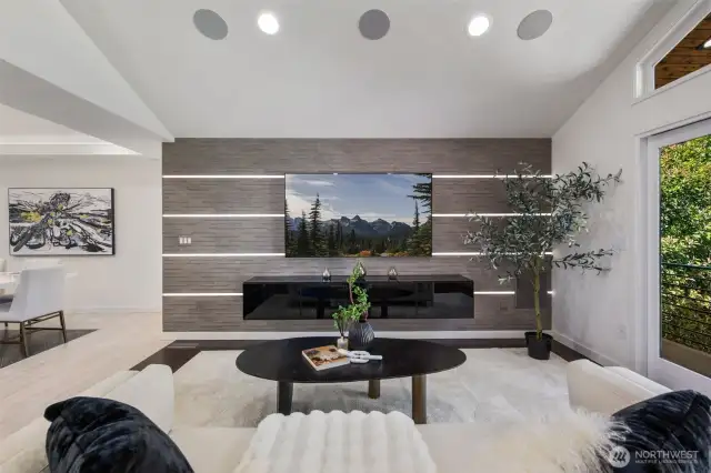 3D tile feature wall with LED lighting, built-in subwoofer, ceiling speakers, and Denon AV receiver—all included and ready for immersive media.