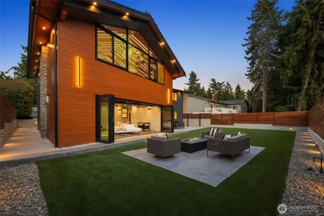 A backyard oasis with low-maintenance turf, stamped patio, and gas fire pit.