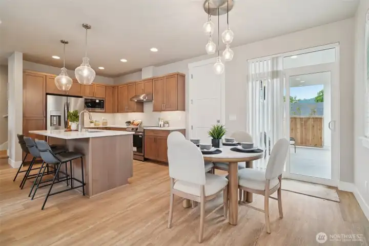 LED under-cabinet lighting and elegant satin nickel chandelier and island pendants