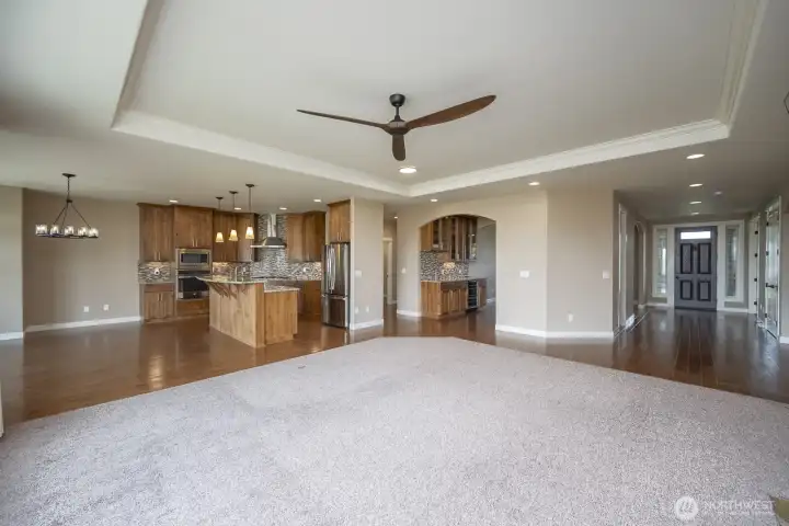 The view of from the Great Room. Entry on the right with entrance into the Dining Room and Wet Bar, the Kitchen and eating areas.