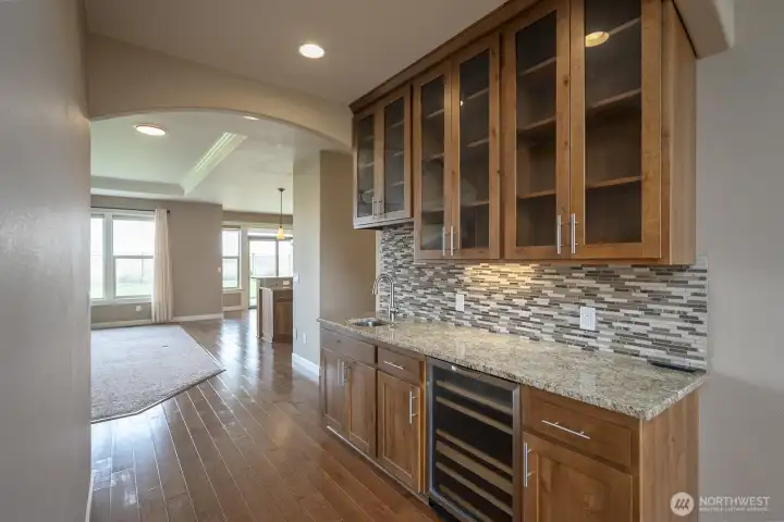 Looking from the Formal Dining Room towards the Kitchen. Note the Wine Cooler, Wet Bar, and all the shelving and cabinetry!