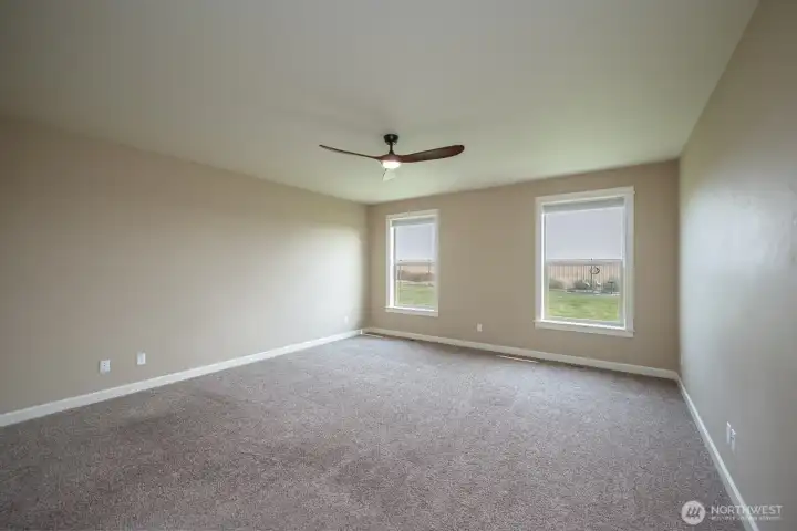 Primary Bedroom with an expansive view toward the completely fenced backyard.