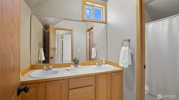 Upper floor main bathroom with double sinks.