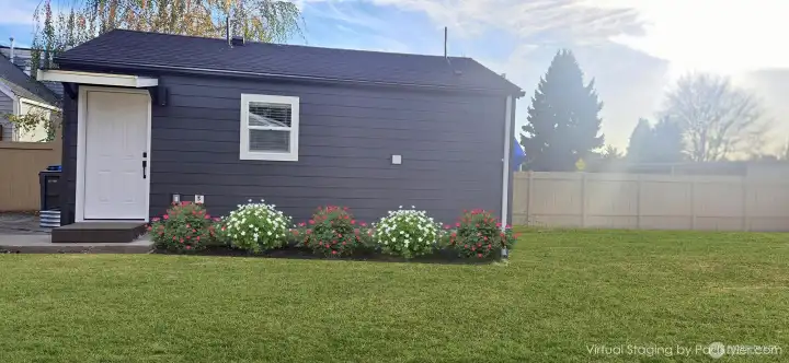 DADU Entrance: Virtually staged with vibrant green grass and flowers to showcase the front yard’s potential! Consider adding an awning to extend the living space and enjoy it year-round.