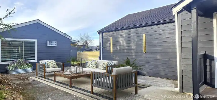 Virtually staged sideyard with furniture, highlighting its outdoor living potential!