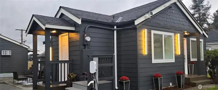 Sideyard at night, showcasing the wired, modern exterior lights.