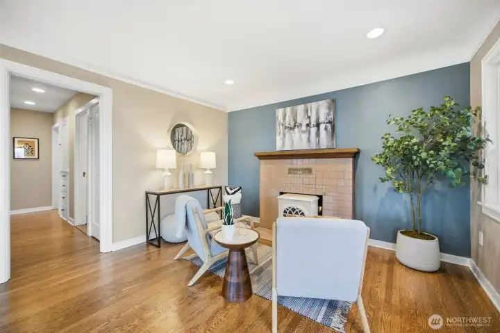 Sitting area in front of wood burning stove features original fireplace surround tiles.