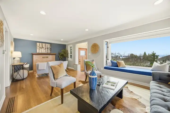 Good sized living room features original, recently refinished floors, picture rail molding and show stopping views through the over-sized front picture window.