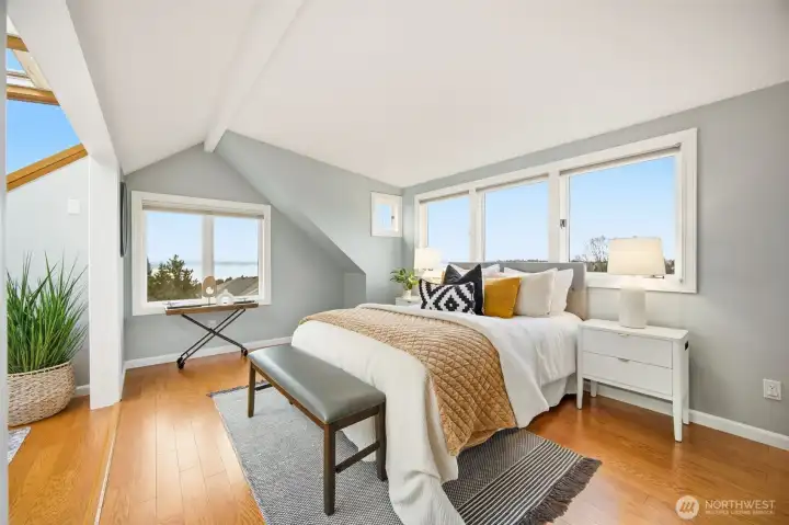 Upper primary bedroom features engineered hardwood floors, a walk-in closet, it's own atrium and vast views from the many windows.