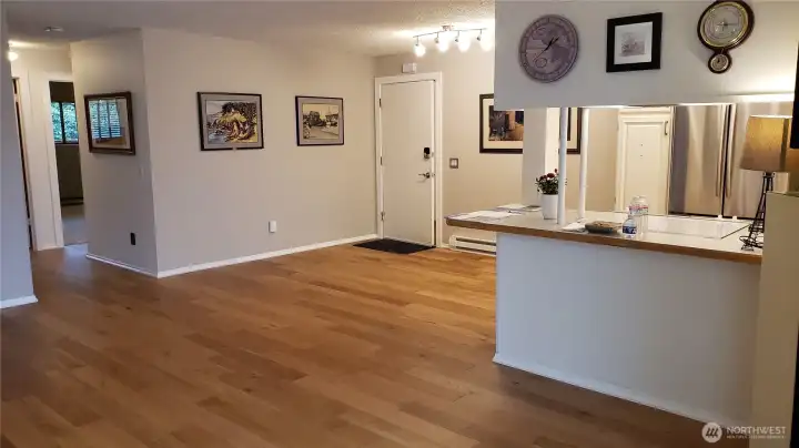 Spacious living dining area with passthrough from kitchen and hallway to bathroom and bedrooms.