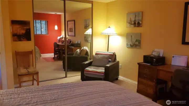 Primary bedroom with plenty of space for a desk and a reading area.