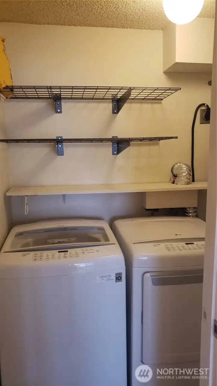 Newer ful lsize washer dryer in utility room
