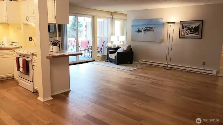 1050 square feet of calming space with the new 2025 deck waiting for your fresh air dining experiences. Updated baseboard heating augments gas fireplace by slider to deck.