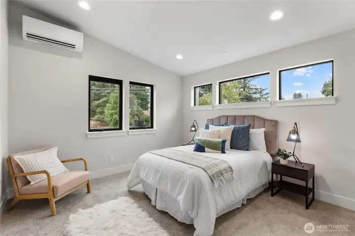 This bedroom offers a calm, inviting atmosphere with soft tones, layered textures, and abundant natural light. Thoughtful furnishings and a clean layout make it an ideal space for rest and relaxation.