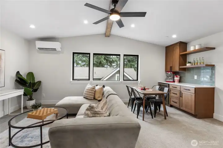 This entertainment space with a bar and kitchenette is perfect for hosting, offering a seamless flow between lounging, dining, and casual drinks. With stylish finishes, natural light, and a relaxed layout, it’s designed for both everyday comfort and lively gatherings.