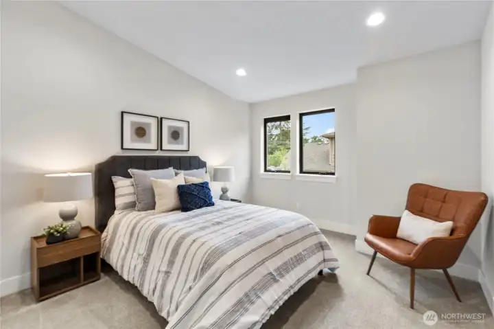 This bedroom offers a clean, contemporary feel with soft neutrals, layered textures, and warm accents.