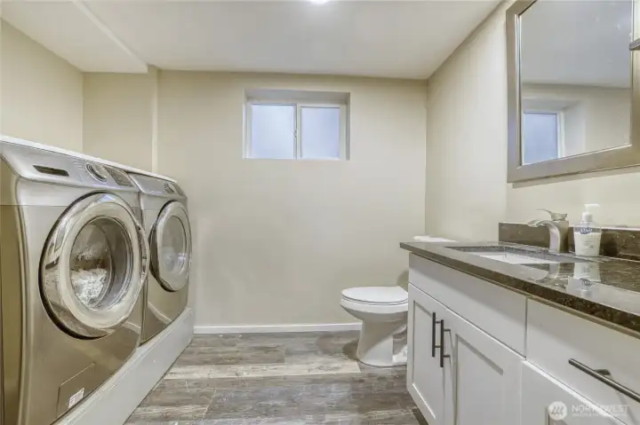 Lower leve 1/2 bath utiility room.  Washer and dryer stay.