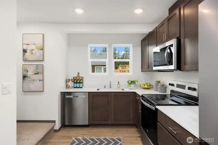 his kitchen offers plenty of workspace along with a spacious pantry for added convenience.