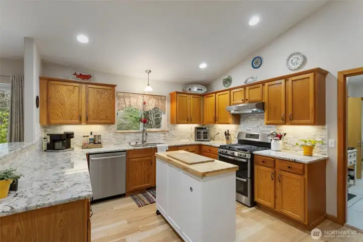 Whip up delicious memories in the kitchen, featuring solid granite counters, tile backsplash, stainless appliances, and walk in pantry.