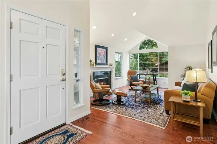 Your living room provides all the comforts, from cathedral ceilings to genuine hardwood floors, a granite fireplace, and lots of light.