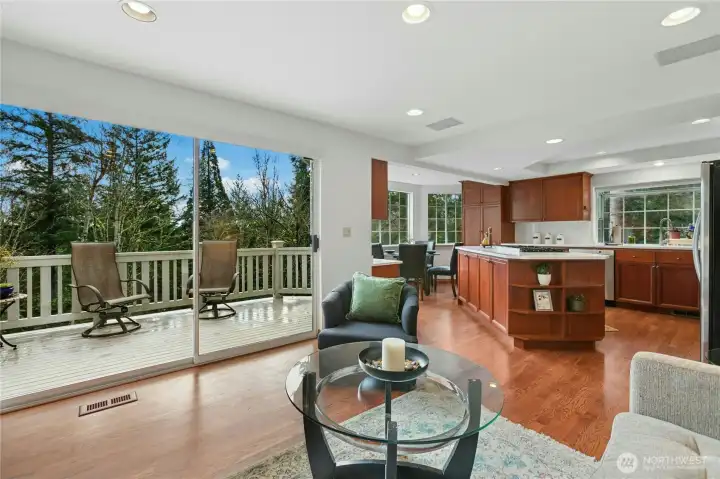 The kitchen and family room open to the main floor deck. Dining alfresco is a breeze. And when the sun is too much, you have electric blinds ready to drop across the sliding door. How easy is that?