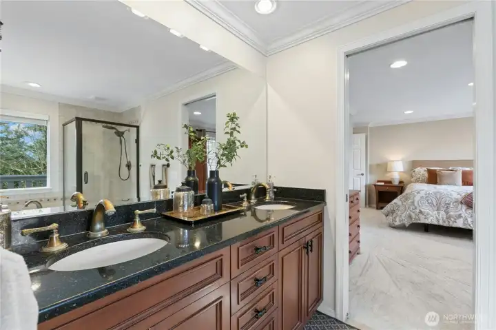 Granite and cherry upgrade this space, and there is room to share with twin sinks.