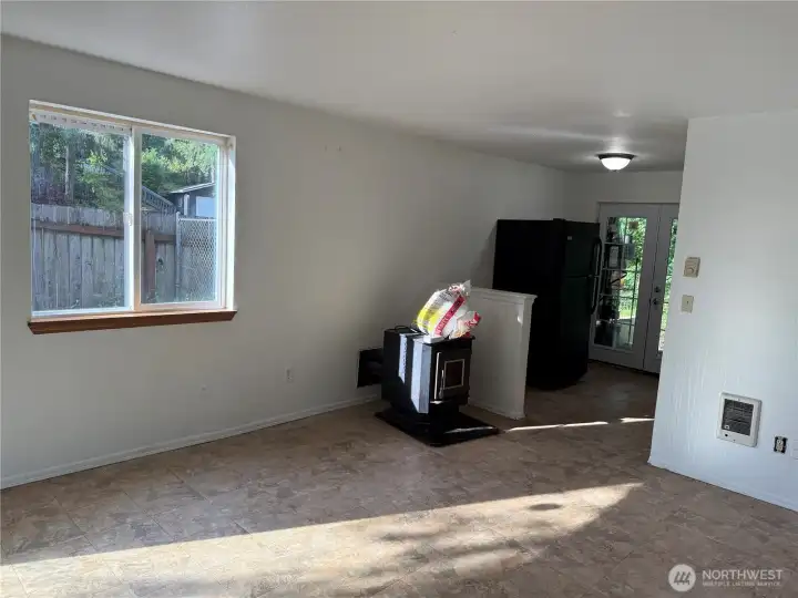 Just off the kitchen  dining area, Large Rec Room , with French doors next to fridge and sliding door behind.